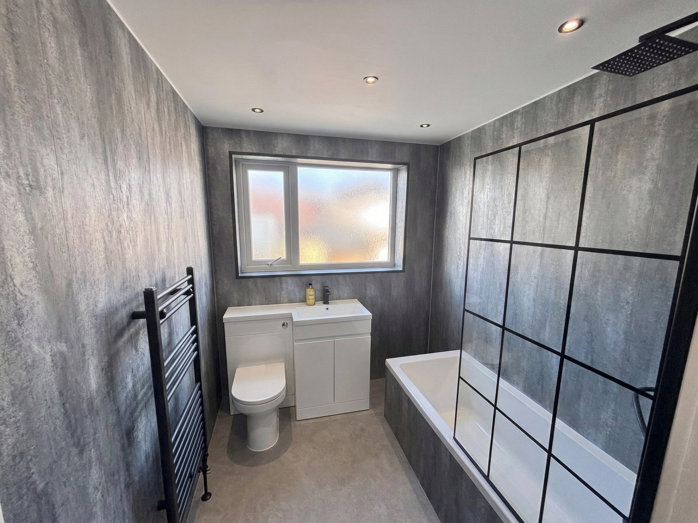 Grey matte bathroom with bath and Crittall screen