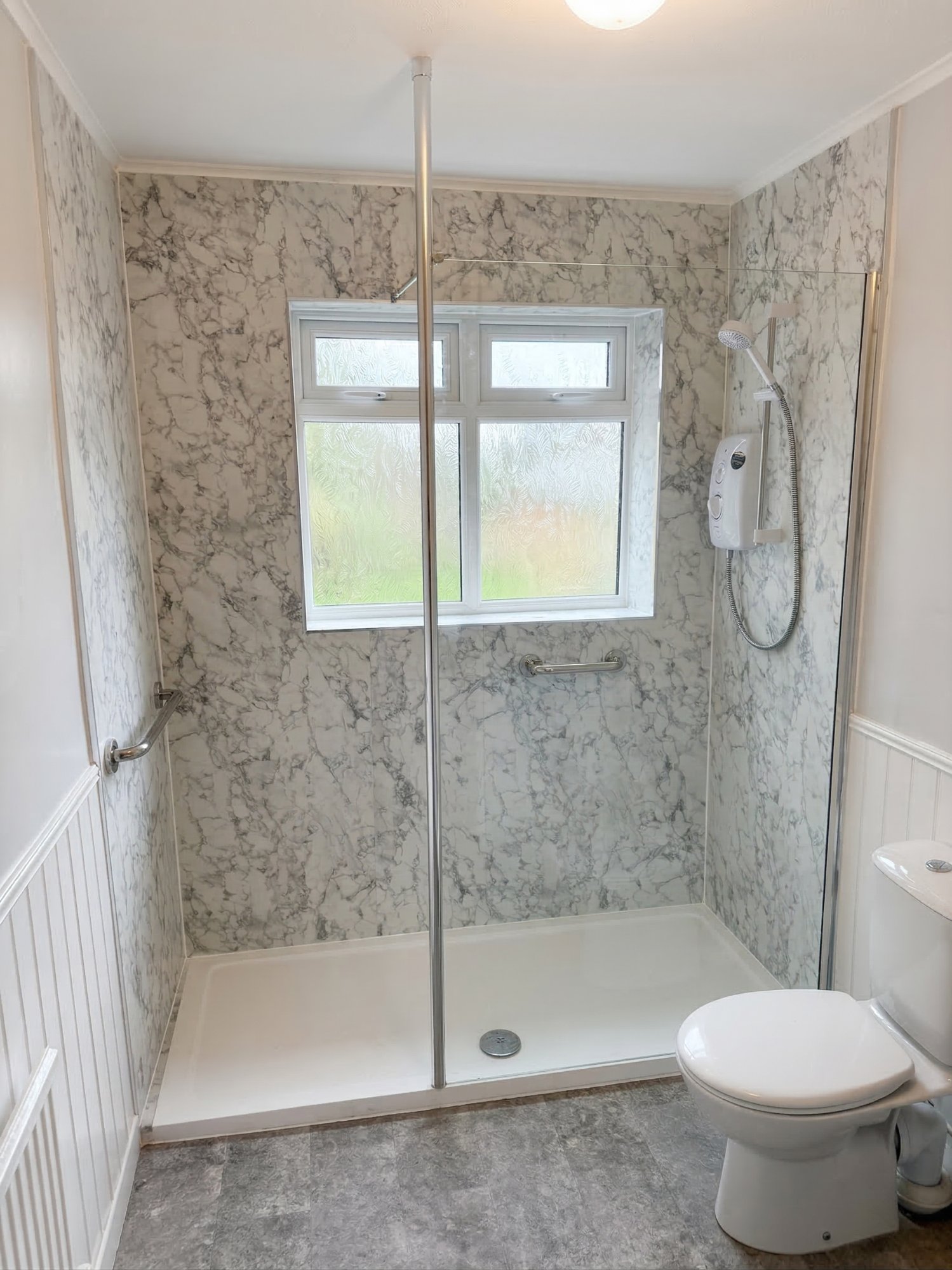 Marble walk-in shower with glass screen
