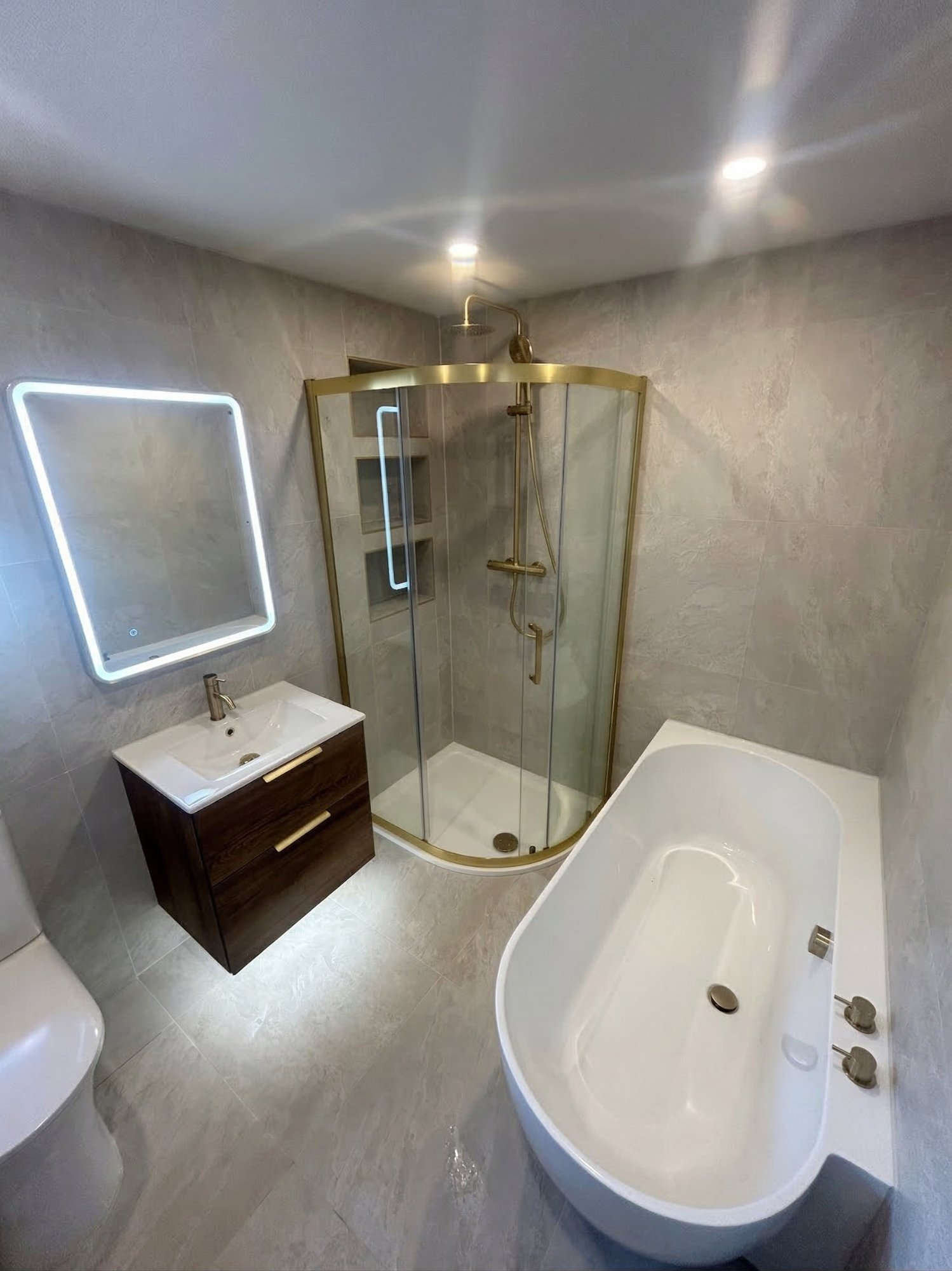 Grey and gold bathroom with freestanding bath