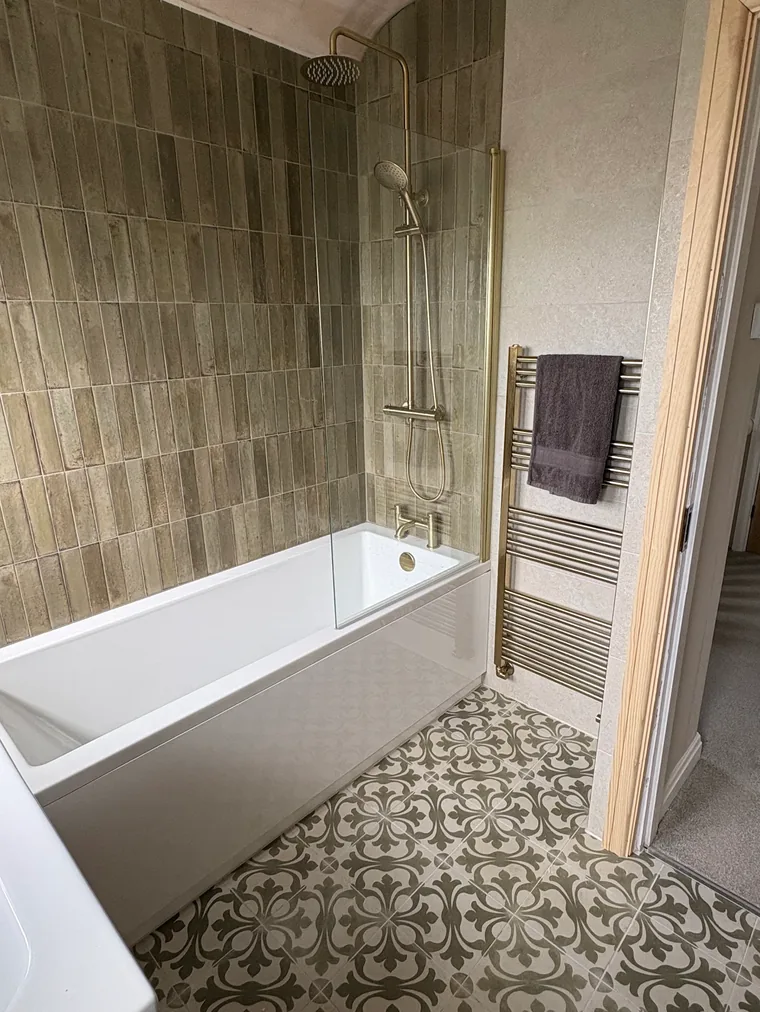 Holly's finished bathroom by Danvers Northwest, bath with brass shower and heated towel rail